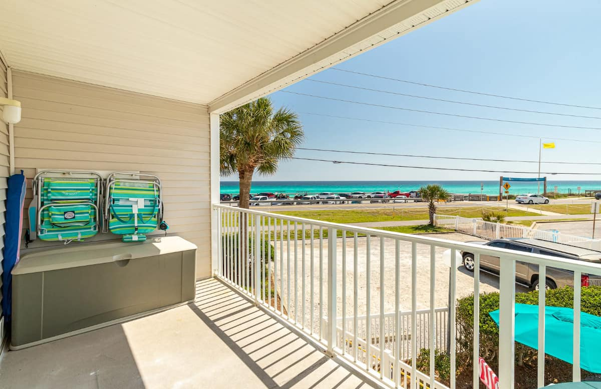 Summer Spell 203 balcony with beach chairs and a Gulf view across Scenic Highway 98